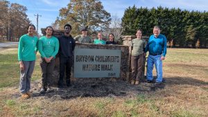 TreesUpstate volunteers and Mayor Atkinson at Bryson Children's Nature Walk sign for tree planting