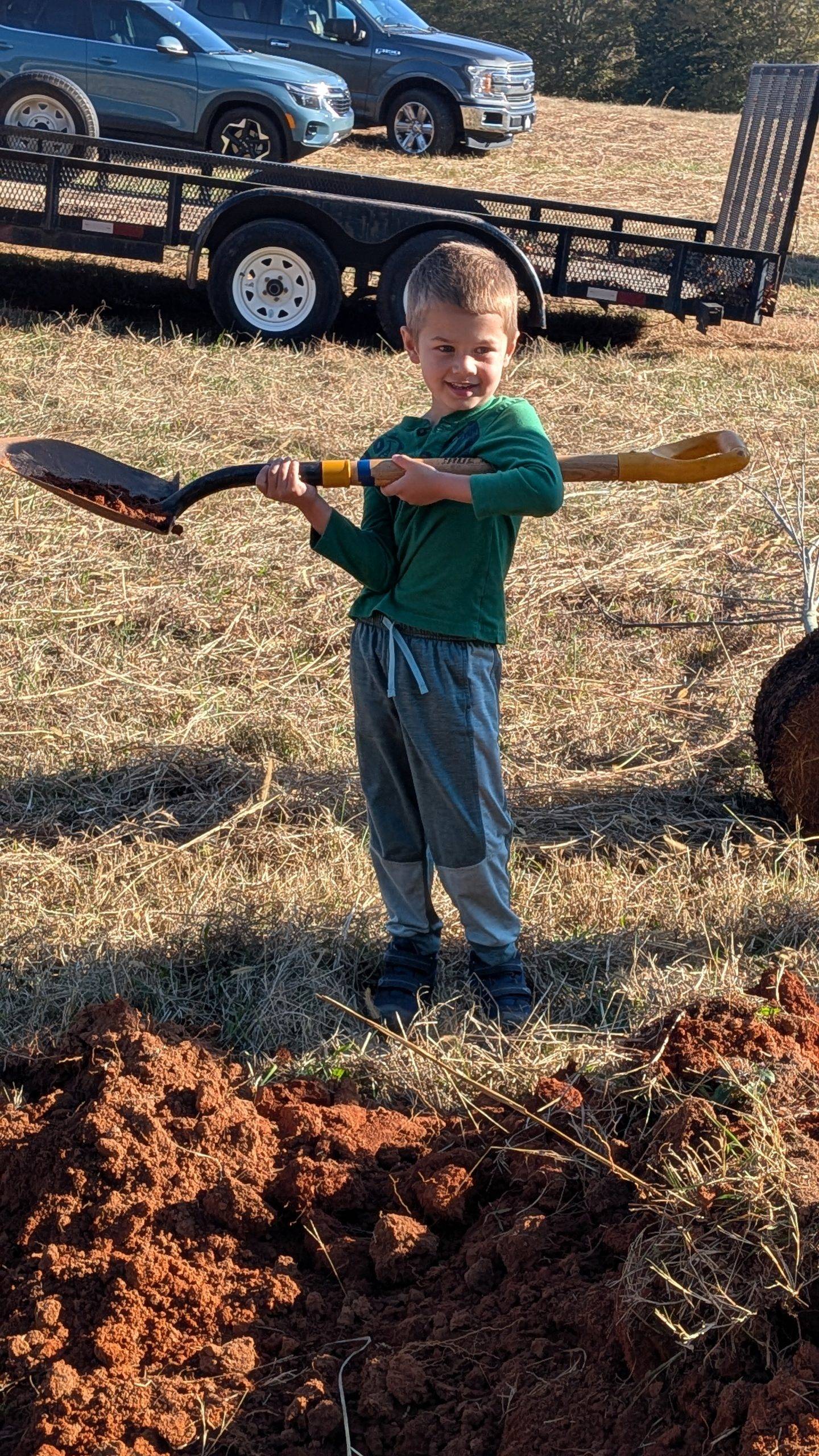 Young boy helping plant trees at Bryson site